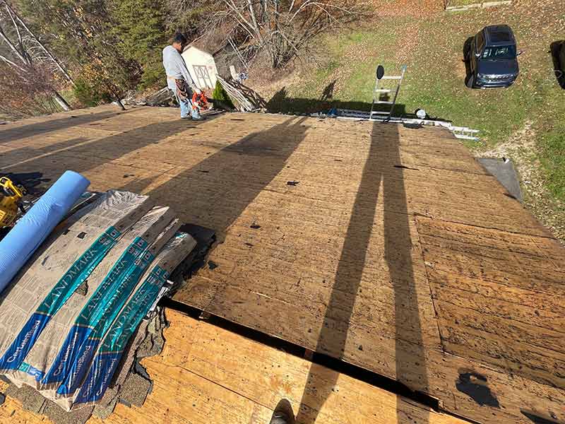 man working on roof of the house